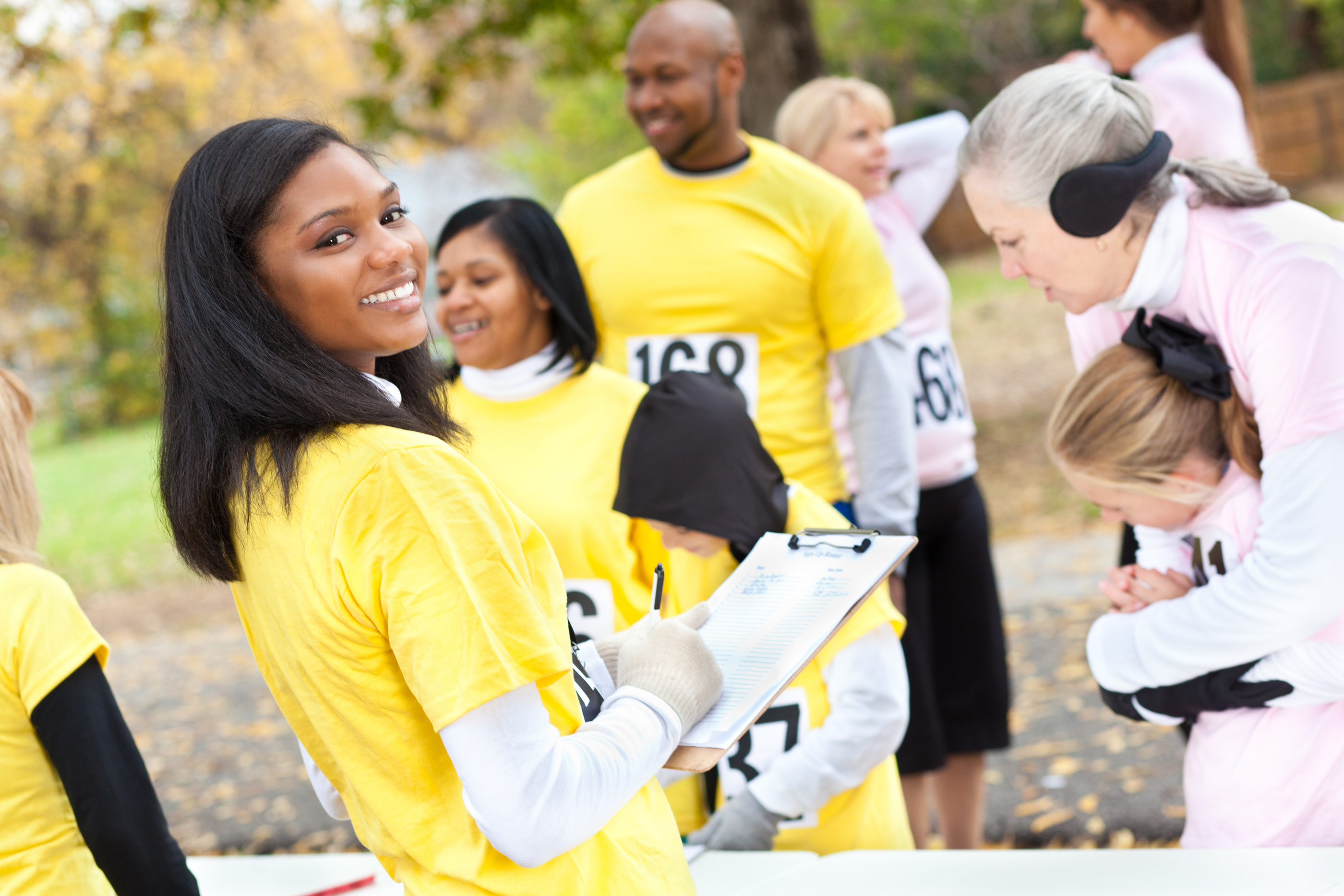 Volunteer signing up charity race runners.