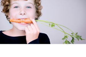 Kid eating carrot