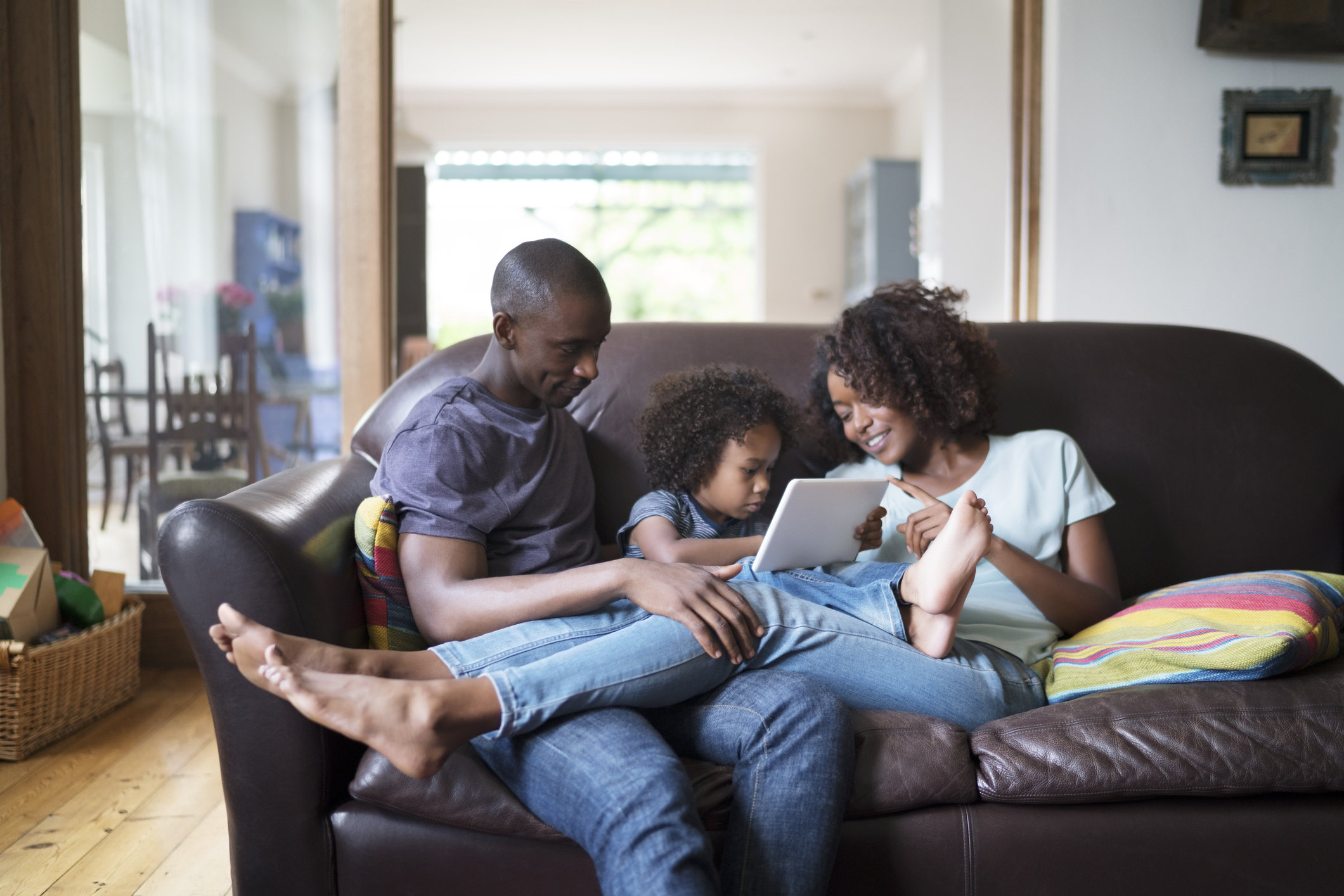 Parents looking at son using digital tablet