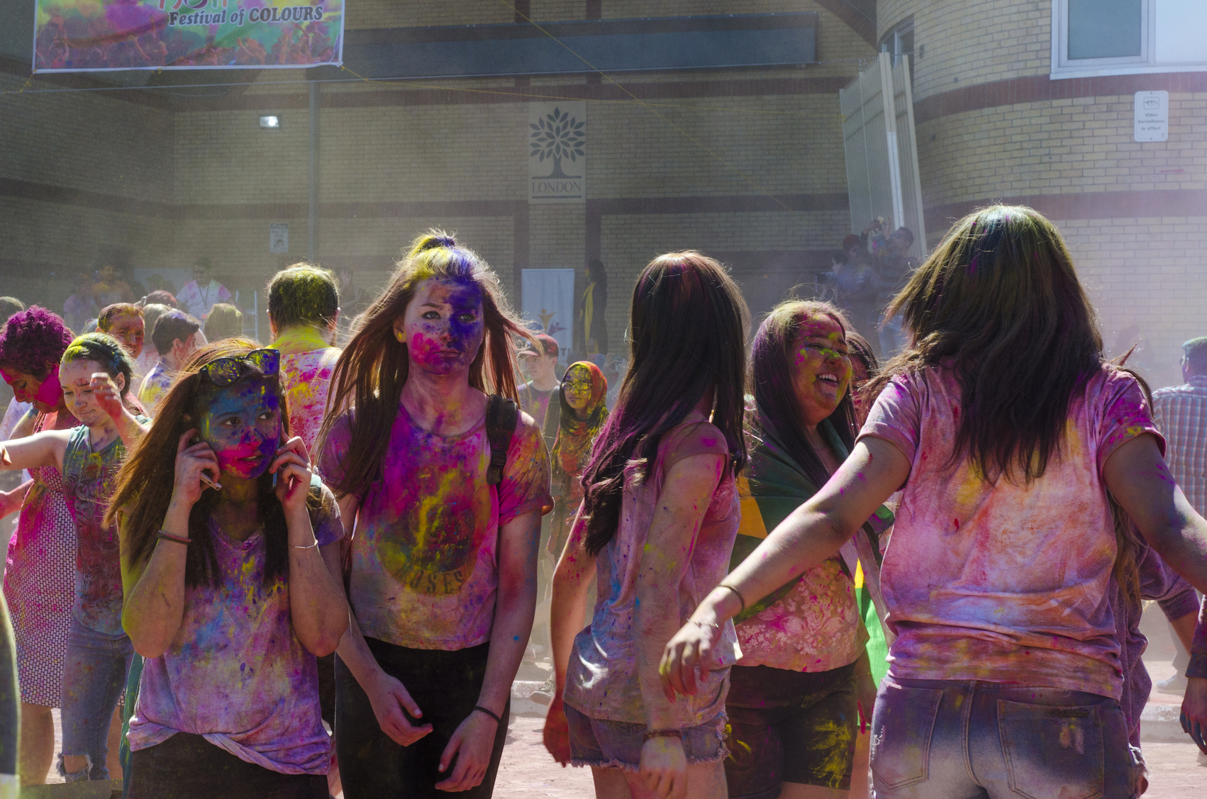 Unidentified colorful guys celebrating at the Festival of Colours